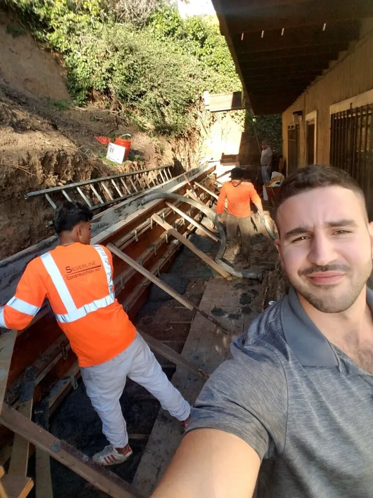 Workers repairing property in San Francisco Bay Area showing situation where homeowner can sell house as is without fixing before a cash sale